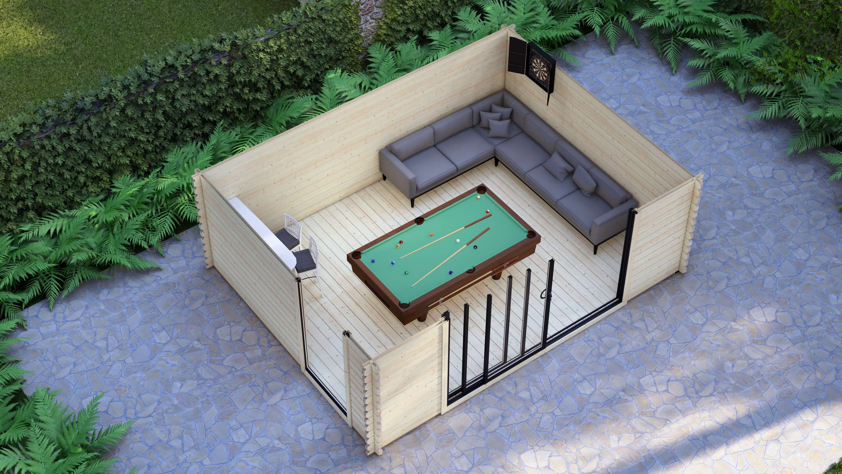 Long ridge roof and interlocking timber logs on Epping 5.0 x 4.0m garden cabin. Outdoor patio with a pool table and sectional sofa surrounded by greenery